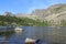 Mountain lake Raduzhnoye, view of high rocky cliffs, hanging stone and Sleeping Sayan in Ergaki Nature Park. Siberia