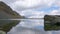 Mountain lake and reflection of boulder and surrounding peaks