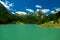 mountain lake Schlierersee, Lungau Austria in pine trees.Transparent green water of lake on blue sky background