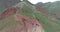 Mountain lake surrounded by peaks and donkeys grazing on its shores, Fann Mountains, Tajikistan.