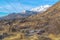 Mountain landscape aerial view with road vehicles and houses on a sunny day