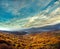 Mountain landscape, autumn forest on a hillside, under the sky