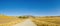 Mountain landscape A country road in a harvested autumn field