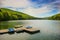 Mountain landscape with docks and pedal cycle boats on lake Gozna surrounded by forest at Valiug