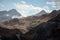 Mountain landscape dusty dirty volcanic slope with a cracked melting glacier against the backdrop of the Caucasus