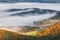 Mountain landscape with foggy valley during autumn morning