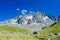 Mountain landscape on the french Alps, Massif des Ecrins. Scenic rocky mountains at high altitude with glacier, green meadows and