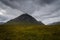 Mountain landscape in Glen Coe with dark clouds hanging over the peaks, Highland, Scotland