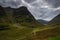 Mountain landscape in Glen Coe with dark clouds hanging over the peaks, Highland, Scotland