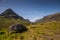 Mountain landscape in the Glencoe area in Scotland, Springtime view mountains with grassland and countryside road in the valley of