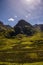 Mountain landscape in the Glencoe area in Scotland, Springtime view mountains with grassland and countryside road in the valley of