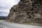 Mountain landscape granite rock hanging over a road in the mountains