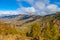 Mountain landscape with green hills and white clouds. Valley wit