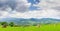 Mountain landscape with hayfield on the foreground