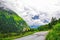 Mountain landscape with heavy clouds and winding asphalt road