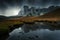 Mountain landscape with lake and dark spectacular clouds in the