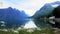 Mountain landscape and lake Oppstrynsvatnet in Oppstryn, Sogn og Fjordane county in Norway with flowers in foreground and traffic