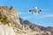 Mountain landscape and landing passenger aircraft. Travel to the mountainous countries