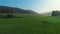 Mountain landscape of pasture and grazing horses, foggy sunrise, aerial 4k video