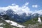 A mountain landscape with a peak and a stream