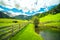 Mountain landscape pond lake wooden fence green grass wide angle distant horizon