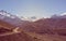 Mountain landscape with road running through wasteland.