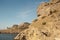 Mountain landscape, rocks and reefs surrounding the blue Bay of the Black sea.