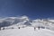 Mountain landscape with skiers skiing away