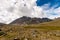 Mountain landscape. Slope with a mountain with a hidden top in the clouds.