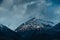 Mountain landscape with snowy peaks in overcast weather