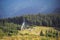 Mountain landscape at sunshine. Tourist tents in forest