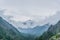 Mountain landscape, valley, forest with green trees and beautiful blue sky with clouds.