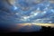 Mountain landscape with wave of fog and dark cloudy sky. Dreamy