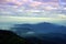 Mountain landscape with wave of fog and dark cloudy sky on the t