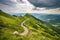 mountain landscape, with winding road and clouded sky, on a journey of discovery