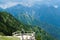 Mountain landscape, woman on a wooden terrace, admire the beautiful view of Albanian Alps