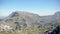 Mountain landscapes covered with green vegetation against blue sky. Art. Panorama of mountain valley with rocks covered