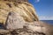 Mountain with large stone in front at the beach