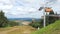 Mountain lift carries tourists and luggage up and down the Ore mountains against the backdrop of the summer