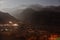 Mountain with little snow on the top with lighted village below in the winter night at Lachung in North Sikkim, India