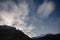 Mountain with little snow on the top and moving cloud in the blue color night with stars in winter at Lachung in North Sikkim.