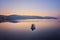 mountain and lonely motor boat reflected sunrise in a calm sea, Marmaris