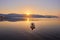 mountain and lonely motor boat reflected sunrise in a calm sea, Marmaris