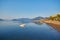 mountain and lonely motor boat reflected sunrise in a calm sea, Marmaris