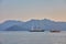 mountain and lonely motor boat reflected sunrise in a calm sea, Marmaris