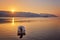 mountain and lonely motor boat reflected sunrise in a calm sea, Marmaris