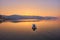 mountain and lonely motor boat reflected sunrise in a calm sea, Marmaris