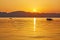 mountain and lonely motor boat reflected sunset in a calm sea, Marmaris