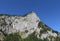 Mountain massif, green forest and blue sky.