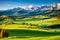 Mountain meadow and houses in Gardena valley and Seceda peak , background Alpe di Siusi or Seiser Alm in the